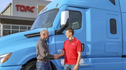 Daimler Trucks North America CEO, Roger Nielsen (left), shakes hands with Torc CEO, Michael Fleming.
