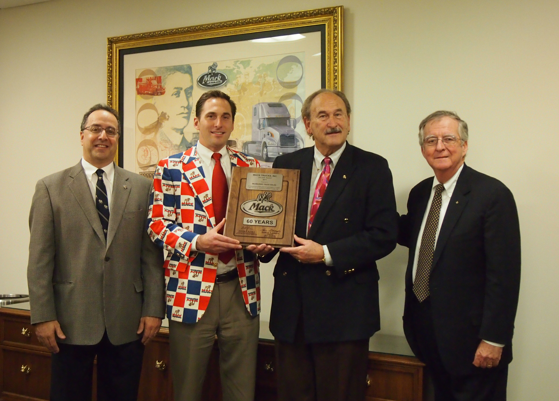 Mack Trucks presented a plaque to David and Roger Kriete of the Kriete Group Inc to honor their 60 years of service as a Mack dealer Pictured from left to right are David Barletta Mack Central Region vice president David Kriete CEO and dealer principal for the Kriete Group Inc Roger Kriete chairman of the Kriete Group Inc and Kevin Flaherty president of Mack Trucks North American sales amp marketing