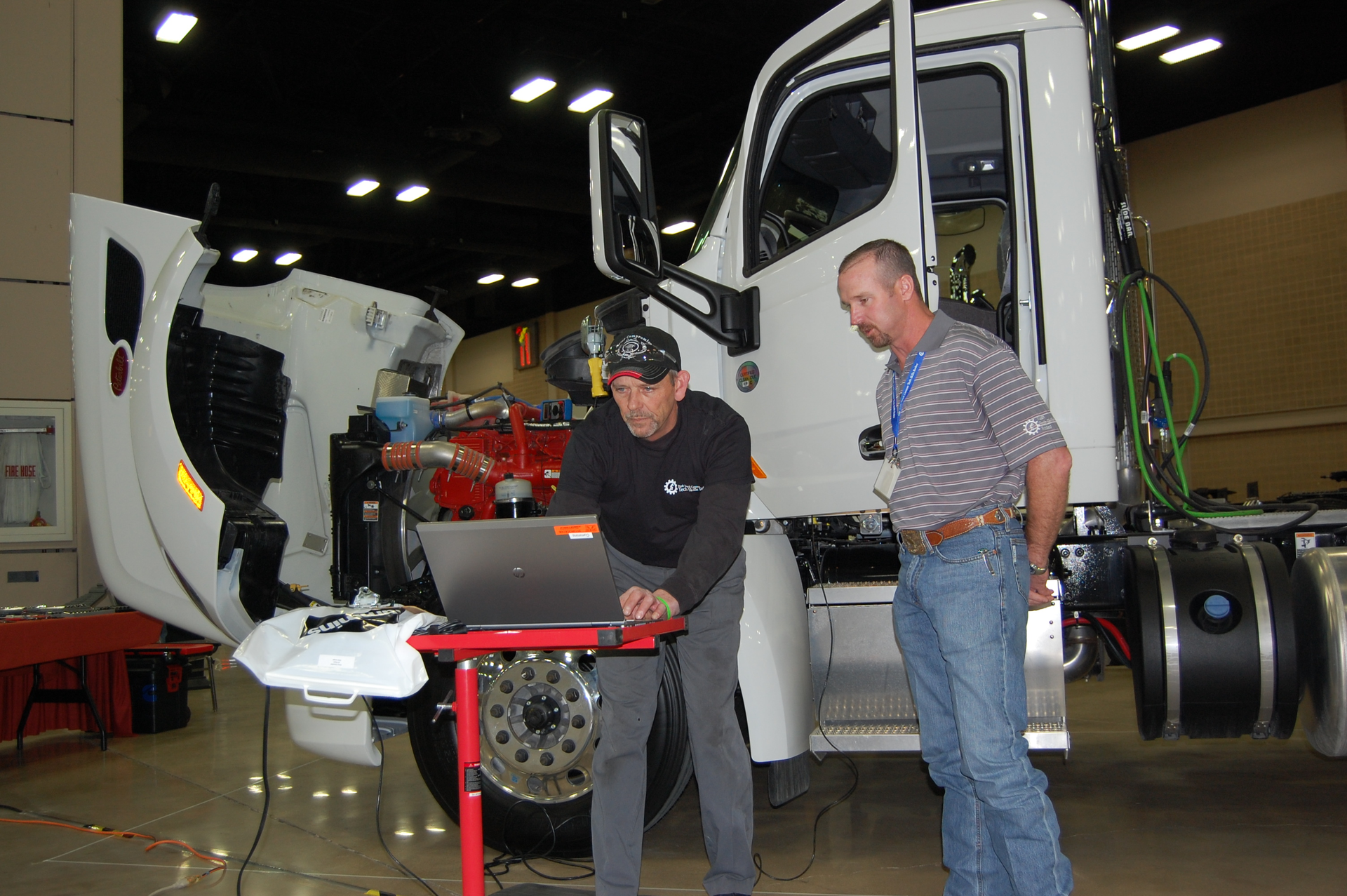 Chris Zweifel left competes in the Cummins engine category at the 2013 Rush Truck Centers Technician Skills Rodeo under the watchful eye of contest judge Josh Washburn a regional engine training manager for Cummins Southern Plains