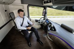 Driver of MercedesBenz Future Truck 2025 attends to other tasks while vehicle in selfdriving mode Driver of MercedesBenz Future Truck 2025 attends to other tasks while vehicle in selfdriving mode