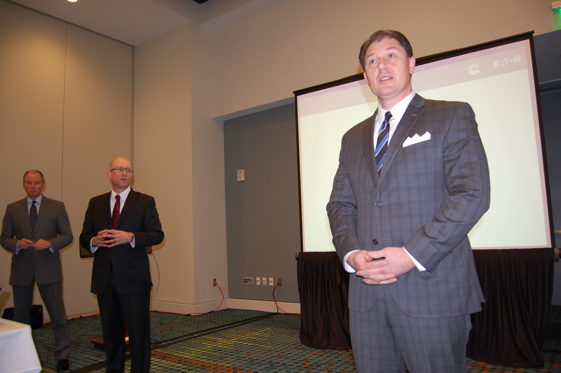 Mike Taylor with Cummins foreground and Eaton39s Ryan Trzybinski at immediate left discuss the fuel savings potential of the mediumduty focused SmartAdvantage powertrain due for release in July