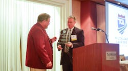 TCA president Brad Bentley presents TCA&rsquo;s 2015 Clare C. Casey Award to Dean Newell, vice president of safety and training for Maverick Transportation.