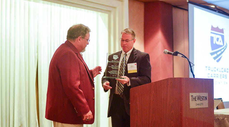 TCA president Brad Bentley presents TCA&rsquo;s 2015 Clare C. Casey Award to Dean Newell, vice president of safety and training for Maverick Transportation.