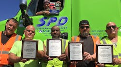 Smokey Point Distributing drivers proudly display the Platinum National Safety Award presented to their company by Great West Casualty Company, a leading insurer of trucks and fleets. This is the 7th time that Great West has presented Smokey Point Distributing with its highest-level safety award. Inside truck (top) - Dave Miller. Outside truck (L to R) - Rick Terletter, Doug Larson, Kelly Robertson, Les Robarge and Jimmy Galvin.