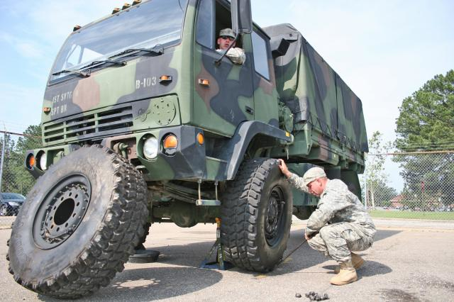 SPC Don Gray a heavy equipment operator in the 618th Engineer Support Company 37th Engineer Battalion 20th Engineer Brigade XVIII Airborne Corps tests his time in changing a tire on an M1078 lightmedium tactical vehicle Photo courtesy US Army