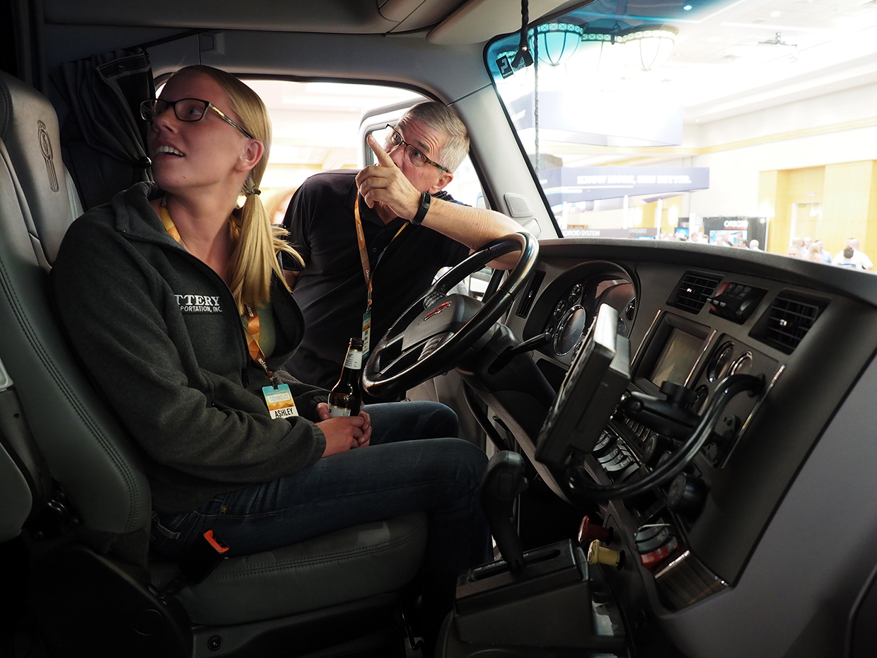 Attendees check out a Kenworth T680 tractor that PacLease brought to the exhibition hall to help show off available vehicle diagnostics systems View photo gallery from the conference
