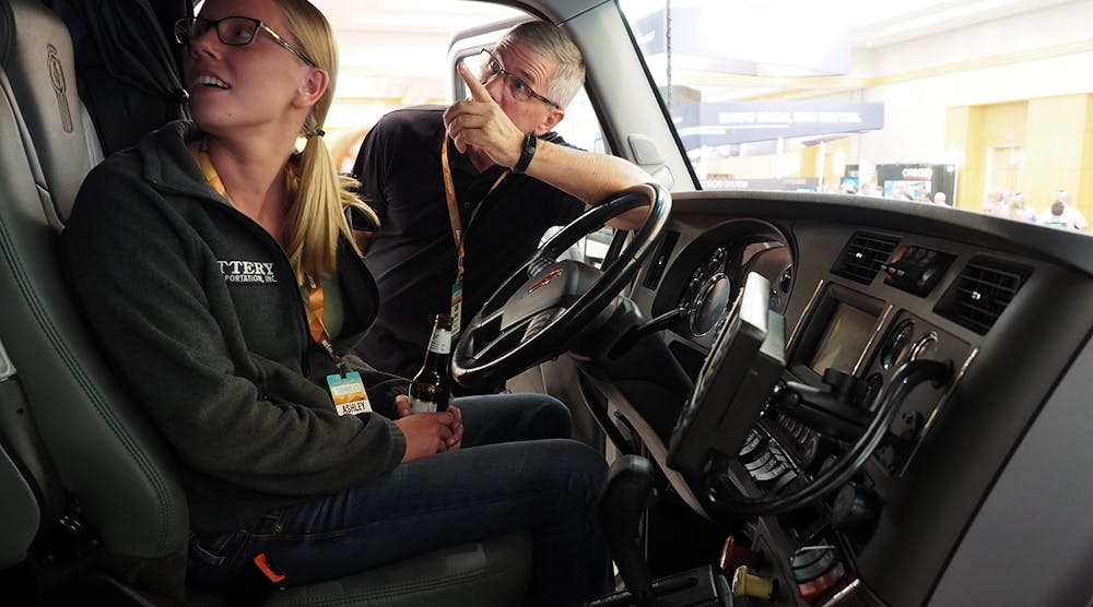 Attendees check out a Kenworth T680 tractor that PacLease brought to the exhibition hall to help show off available vehicle diagnostics systems. View photo gallery from the conference