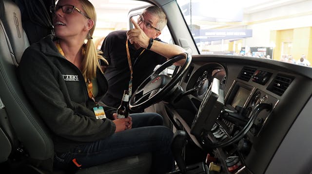 Attendees check out a Kenworth T680 tractor that PacLease brought to the exhibition hall to help show off available vehicle diagnostics systems. View photo gallery from the conference