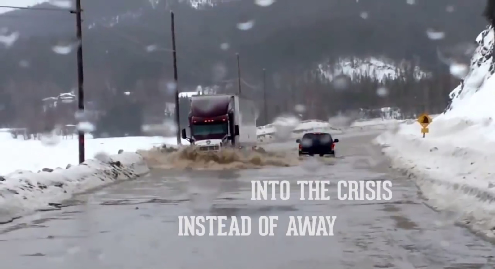 A still from a video released by hiring and recruiting company Fastport for National Truck Driver Appreciation Week shows a tractor trailer plowing through flood waters to deliver supplies