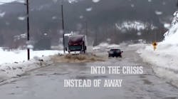 A still from a video released by hiring and recruiting company Fastport for National Truck Driver Appreciation Week shows a tractor trailer plowing through flood waters to deliver supplies.