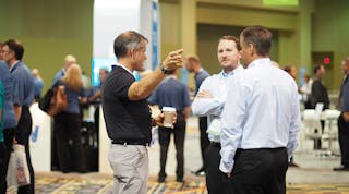 Attendees and exhibitors mingle at the TMW Transforum conference in Orlando, FL, where ALK Technologies announced that its navigation and routing technology has been certified for use with a number of TMW Systems&apos; software products. (Photo by Aaron Marsh)