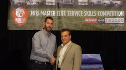 Tom Marchini of Hino Trucks, right, congratulates Hino Trucks Service Skills Competition champion David Taylor of K. Neal, left.