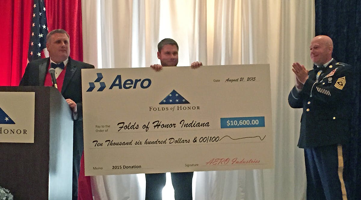 Jeff Boyd, Aero Industries&apos; vice president of sales and marketing, holds the company&apos;s $10,600 check donated to Folds of Honor. Standing with Boyd are Dan Rooney, at right, founder of Folds of Honor, and Michael Daggett, executive director of Folds of Honor Indiana.