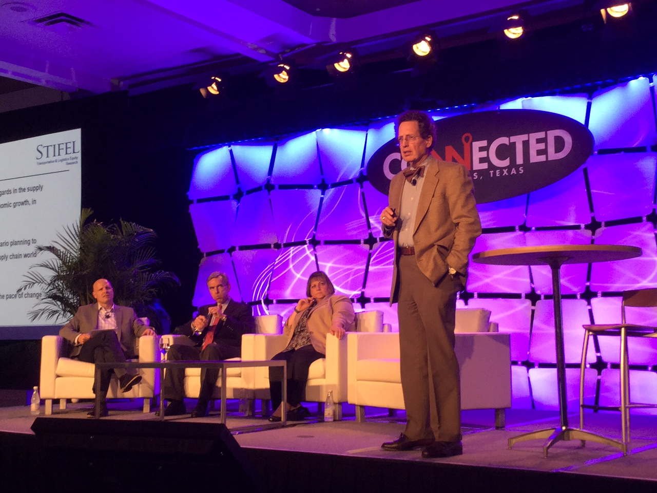 Economist Noeumll Perry senior consultant for FTR speaks at Connected 2015 the Truckstopcom user conference in Dallas this week Seated l to r are Internet Truckstop Group CMO Brent Hutto Stifel Managing Director John Larkin and NASSTRAC Exec Dir Gail Rutkowski