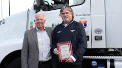 Reddaway President and CEO T. J. O&apos;Connor, left, stands with driver Scott Bunn at a ceremony this week recognizing Bunn for reaching 3 million miles without a preventable accident. (Photo courtesy Reddaway)