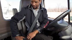 A photo showing a commercial truck driver buckling up from FMCSA&apos;s Commercial Motor Vehicle Safety Belt Facts brochure.