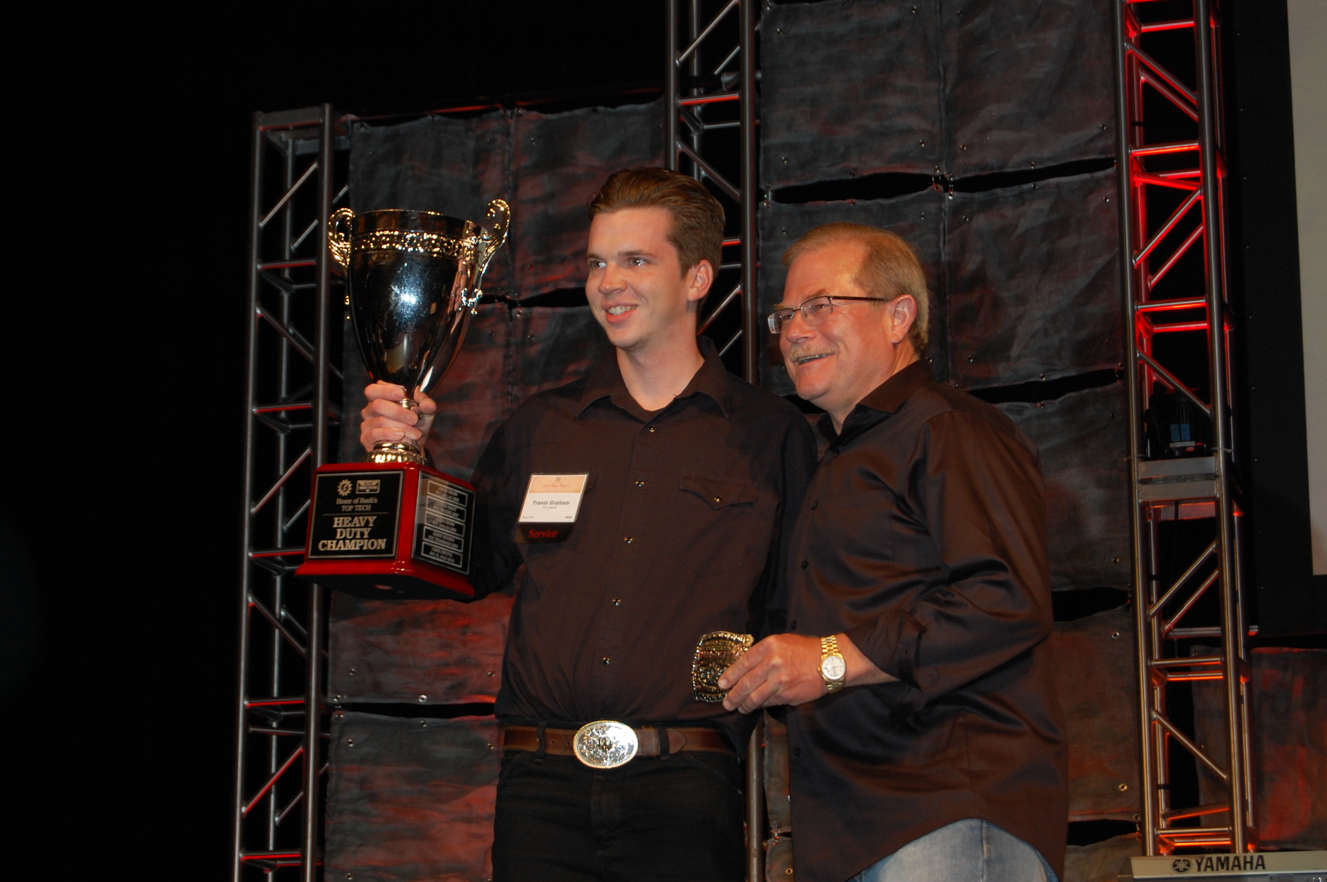Travis Graham at left took home double honors at the 10th annual Rush Truck Centers RTC Technician Skills Rodeo W M quotRustyquot Rush on the right chairman president and CEO of Rush Enterprises RTC39s parent company handed out the awards Photo by Sean KilcarrFleet Owner