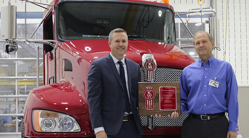 Jason Skoog, Kenworth assistant general manager for sales and marketing, left, presents a commemorative plaque and the keys to the 150,000th truck &ndash; a new Kenworth T370 &ndash; built at the PACCAR-Ste.-Therese plant to Rich Demski, Florida division chief engineer and commercial chassis manager for Pierce Manufacturing.