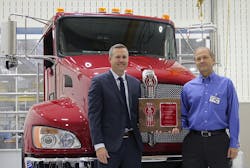 Jason Skoog Kenworth assistant general manager for sales and marketing left presents a commemorative plaque and the keys to the 150000th truck ndash a new Kenworth T370 ndash built at the PACCARSteTherese plant to Rich Demski Florida division chief engineer and commercial chassis manager for Pierce Manufacturing Jason Skoog Kenworth assistant general manager for sales and marketing left presents a commemorative plaque and the keys to the 150000th truck ndash a new Kenworth T370 ndash built at the PACCARSteTherese plant to Rich Demski Florida division chief engineer and commercial chassis manager for Pierce Manufacturing