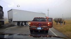 A still from the video posted by WHIO-TV 7 shows the truck being hit by an oncoming train and propelled toward police offers as well as the drivers involved in an earlier accident.