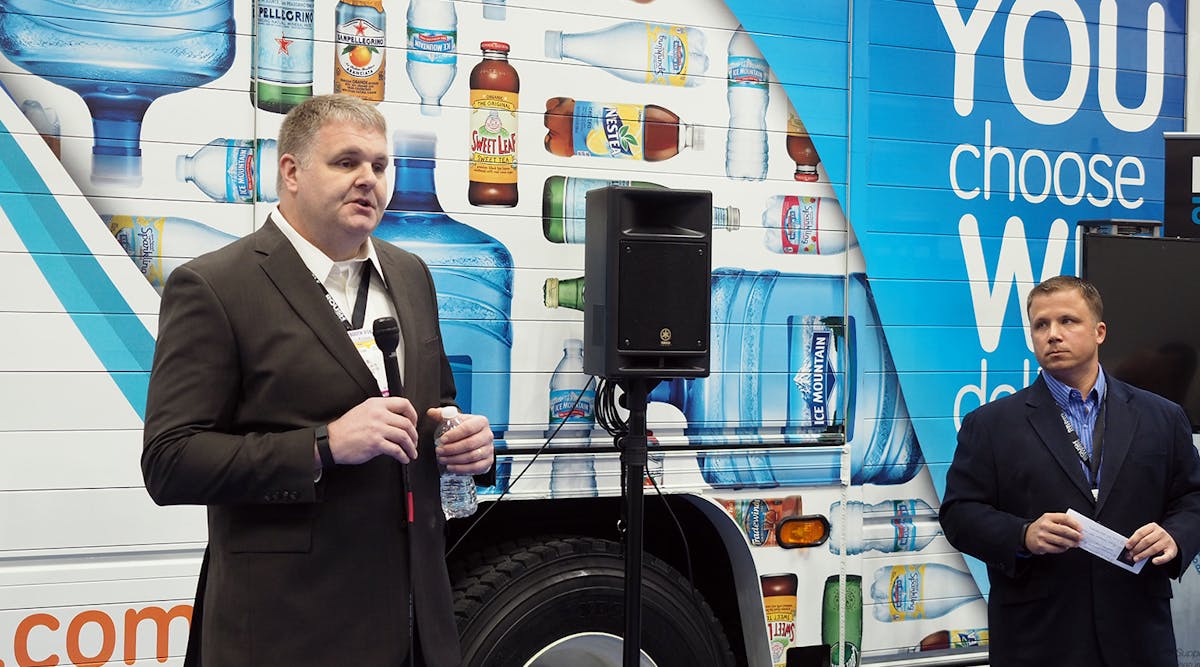 Bill Ardis, left, national fleet manager at Nestl&eacute; Waters North America, stands in front of one of the company&apos;s new Ford F-650 delivery trucks powered by propane at the NTEA Work Truck Show along with ROUSH CleanTech&apos;s Todd Mouw.