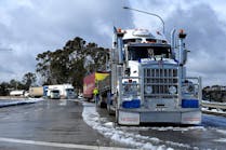 Australia is in the process of eliminating pay-by-the-mile for many of its truck drivers and replacing it with guaranteed minimum hourly wages.