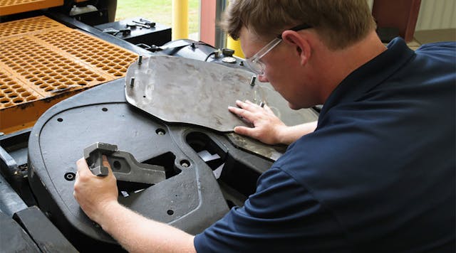 A technician removes a wear plate to rebuild the Fontaine Armor fifth wheel from the top side.