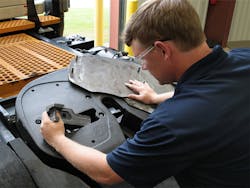A technician removes a wear plate to rebuild the Fontaine Armor fifth wheel from the top side A technician removes a wear plate to rebuild the Fontaine Armor fifth wheel from the top side