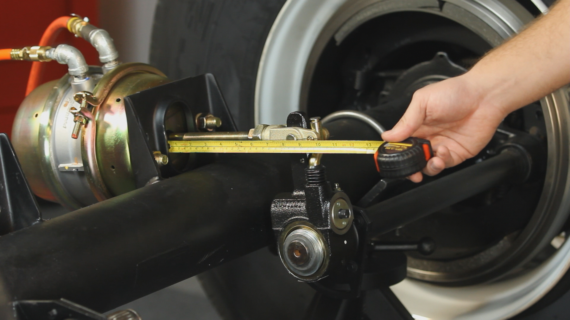 A technician measures the Accuride Gunite Pushrod stroke
