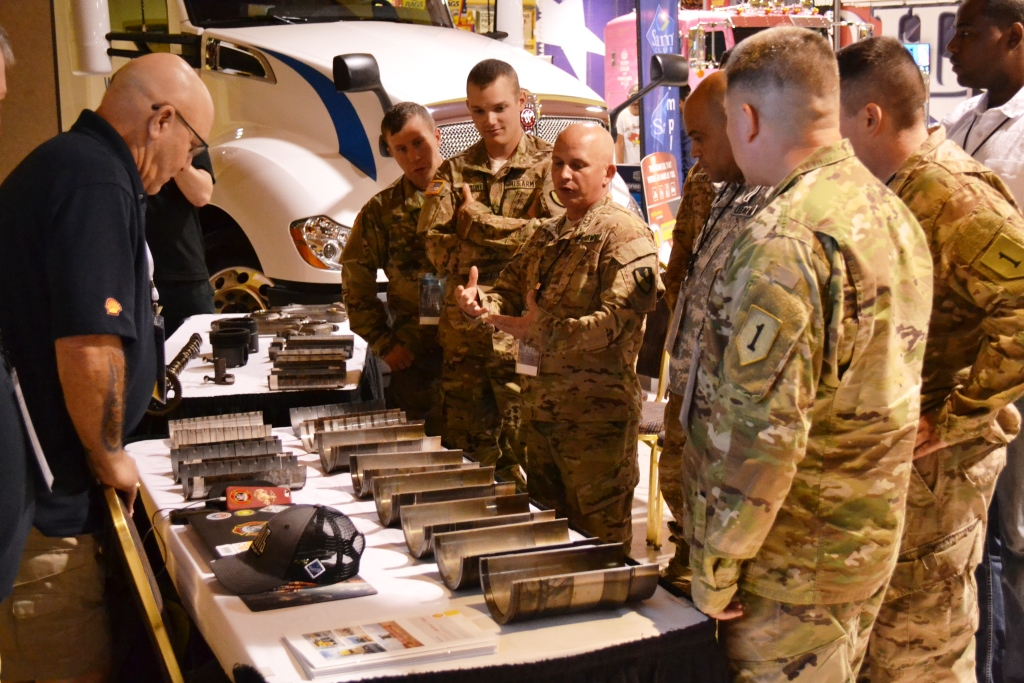 Soldiers interested in trucking careers discuss an engine teardown with Shell39s Howard Hill at SuperRigs in Joplin last weekend