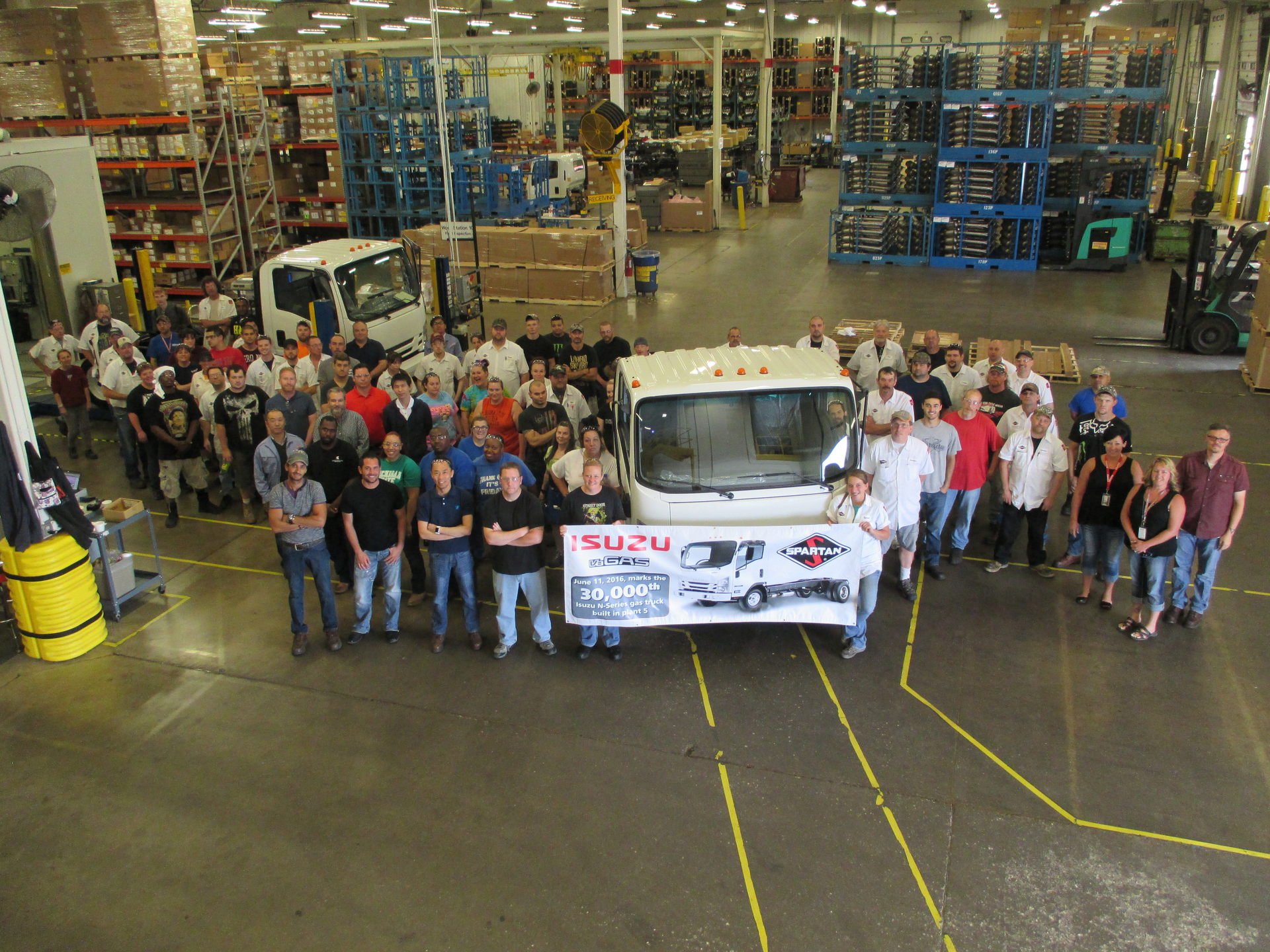 The folks at Isuzu celebrate the production of the 30000th gasolinepowered NSeries truck at the Spartan Motors facility in Charlotte MI