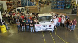 The folks at Isuzu celebrate the production of the 30,000th gasoline-powered N-Series truck at the Spartan Motors facility in Charlotte, MI.