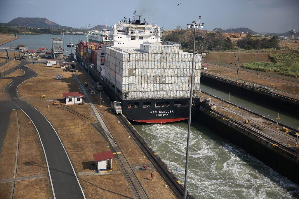 A cargo ship makes its way through the Miraflores locks as it crosses the Panama Canal on April 7 2016 in Panama City Panama A third lane part of the 53 billion Panama Canal expansion project opened June 26