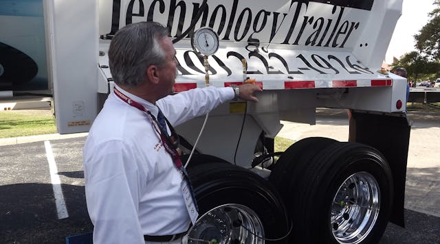 Kevin Hennig from Pressure Systems International shows the Meritor Tire Inflation System by P.S.I., installed on P.S.I. technology trailer at the company&apos;s new facility in San Antonio.