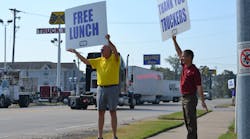Arkansas Trucking Assn. Chairman Butch Rice and Gary Jaworski, a member of the Arkansas Road Team, direct traffic to Thursday&apos;s Driver Appreciation Day picnic.