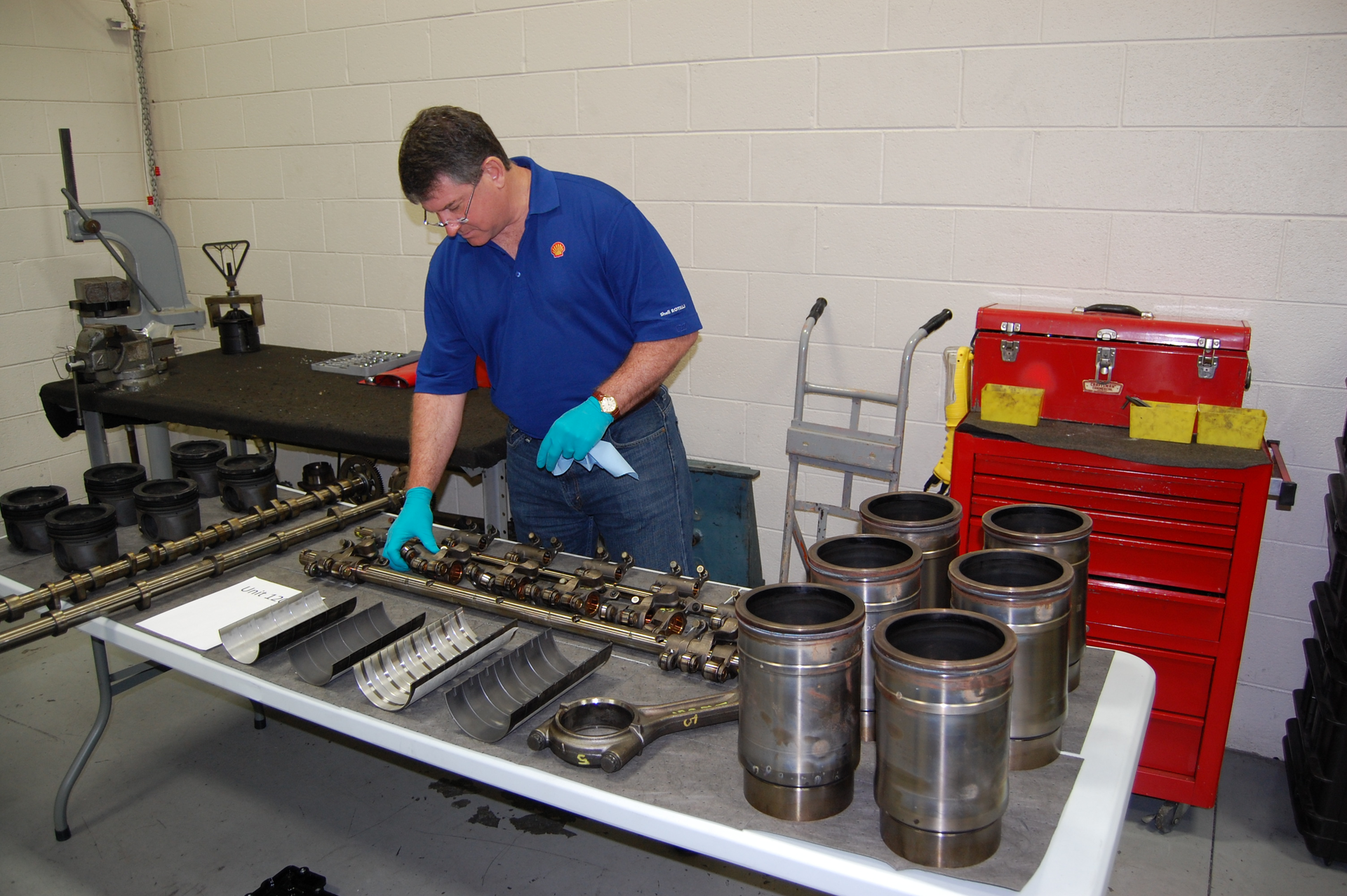 Shell39s Dan Arcy examining engine components following teardown testing conducted two years ago as part of the company39s PC11 development process Photo by Sean KilcarrFleet Owner