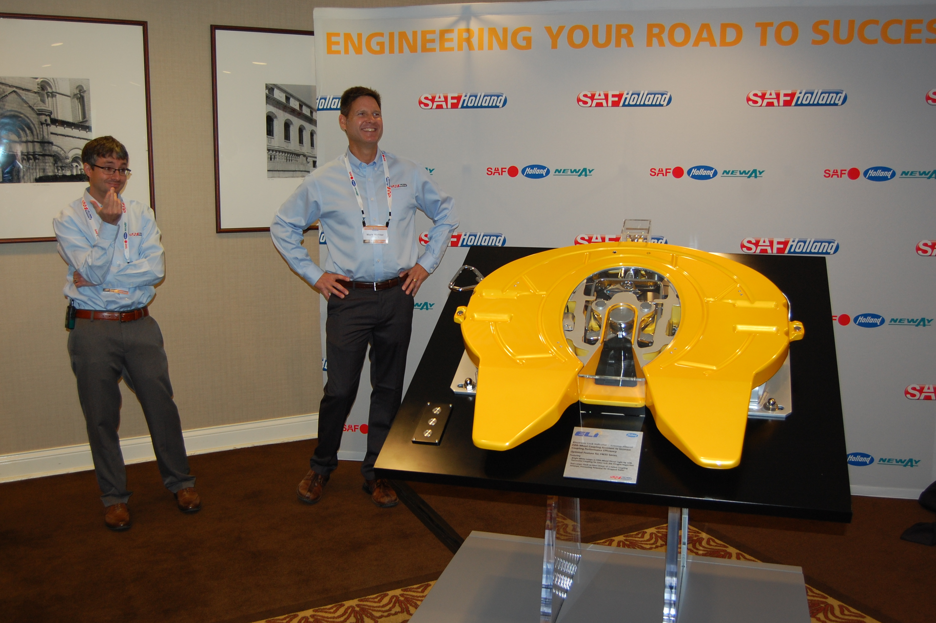 SAFHolland39s Bryan Redeker far left and Mark Molitor with an FW35 fifth wheel equipped with the new ELIte system Photo by Sean KilcarrFleet Owner