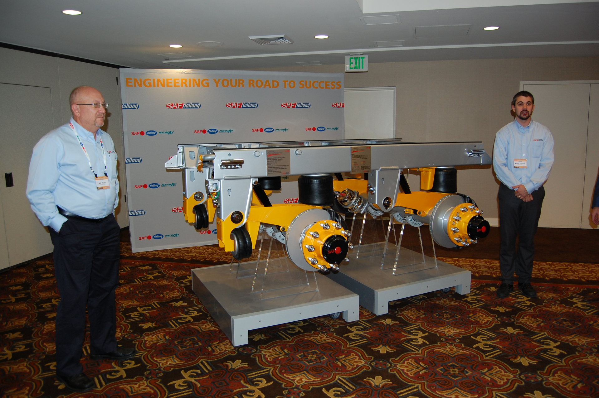 SAFHolland39s Bill Hicks left and Roger Jansen right show off the company39s new CBX40 AeroBeam tandem axle trailer suspension Photo by Sean KilcarrFleet Owner