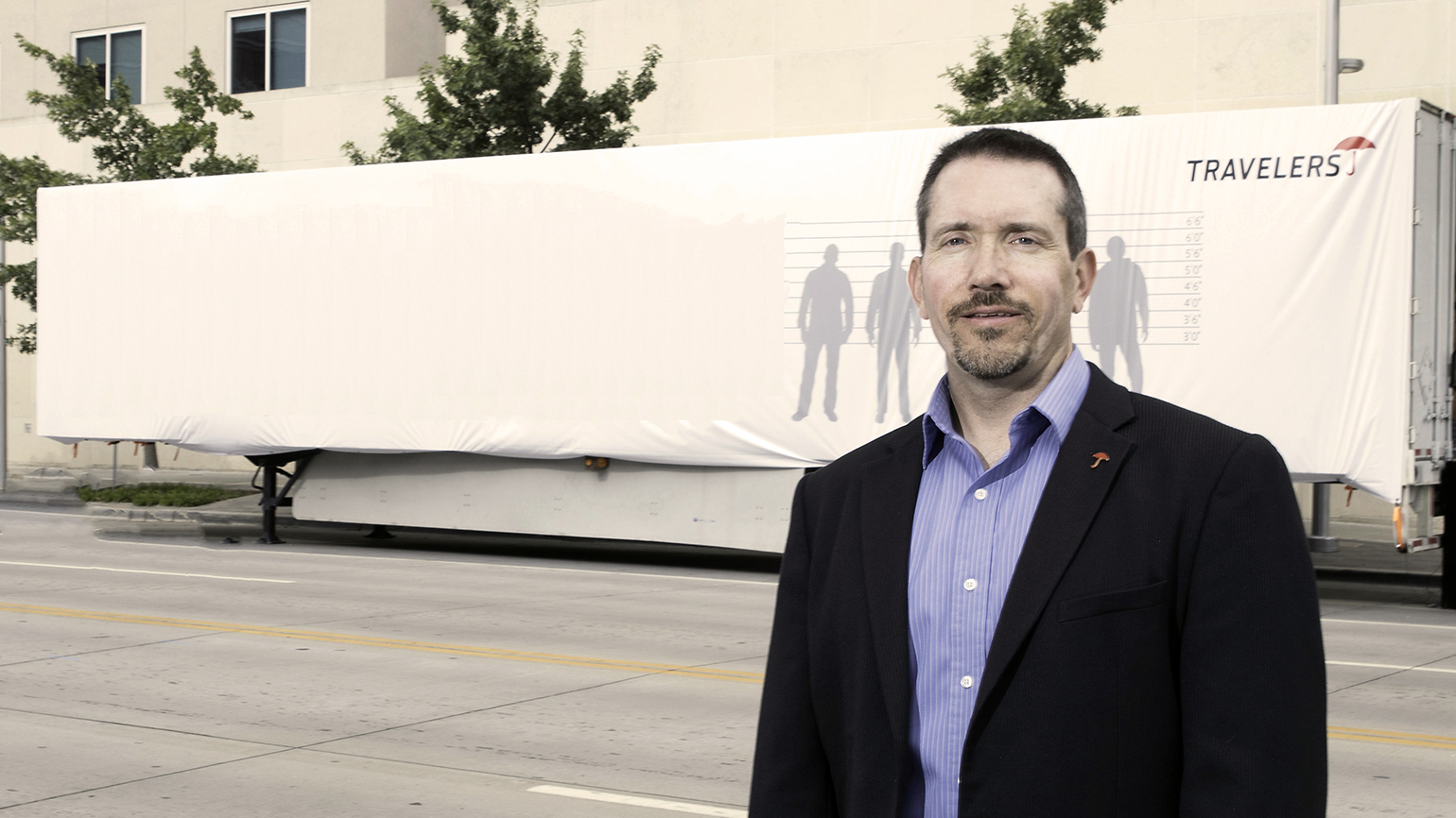 Scott Cornell a transportation crime and theft specialist at the Travelers Companies stands near the disguised Travelers Sting Trailer