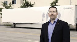 Scott Cornell, a transportation crime and theft specialist at the Travelers Companies, stands near the disguised Travelers Sting Trailer.
