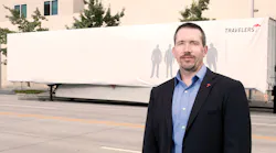 Scott Cornell a transportation crime and theft specialist at the Travelers Companies stands near the disguised Travelers Sting Trailer
