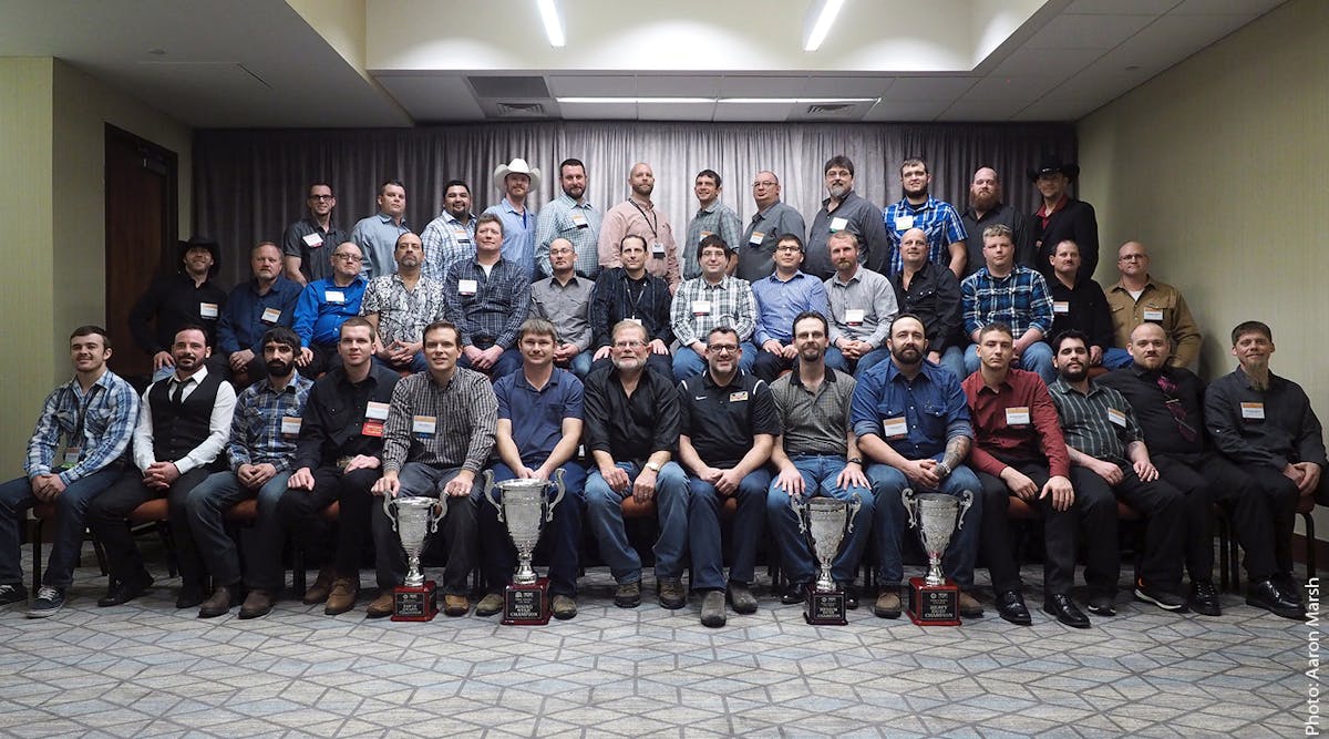 If you&apos;ve made it to this room, it&apos;s safe to say you&apos;re a very skilled truck tech. The winners of the 2016 Rush Truck Centers Tech Skills Rodeo pose together with company CEO W.M. Rusty Rush and winning NASCAR driver Tony Stewart (at left and right-center in front row, respectively) Dec. 13, 2016, in San Antonio.