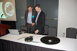 Aperia39s Josh Carter left and FlowBelow39s Josh Butler discuss the new brackets that link Aperia39s Halo Tire Inflator with FlowBelow39s wheel covers Photo by Sean Kilcarr for Fleet Owner