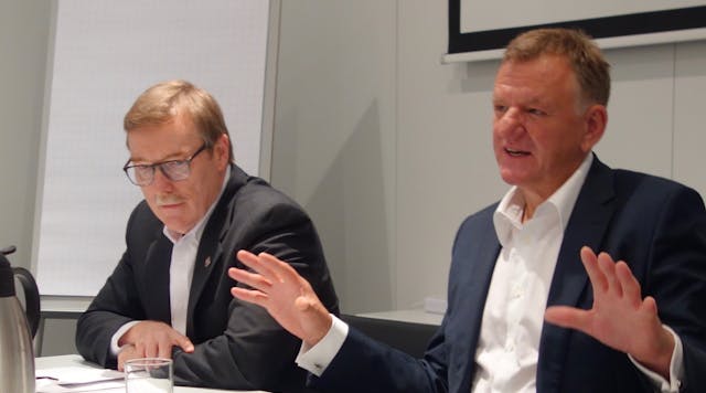 Navistar President and CEO Troy Clarke (left) and VW Truck &amp; Bus head Andreas Renschler speak during a conference at IAA 2016.
