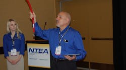 Exotic&apos;s Henry Testa shows off Parker Hannifin&apos;s new low permeation natural gas fuel hose. (Photo by Sean Kilcarr for Fleet Owner)