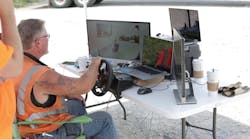 A truck driver with his CDL operates a truck retrofitted with Starsky Robotics radar, cameras, and other gadgets. Like a military drone operator or video gamer with a driving console, the driver sees everything a driver in the cab would see and operate the same controls including steering wheel, brakes and accelerator. (Photo from Starsky Robotics documentary)