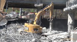 Road crews are seen in this still from a Georgia DOT video working to remove damaged portions of the collapsed Interstate 85 bridge while plans are being finalized for repairs. Disaster-type situations on America&apos;s roadways illustrate the very different and specialized needs of commercial routing and navigation, explains Telogis, a Verizon company.