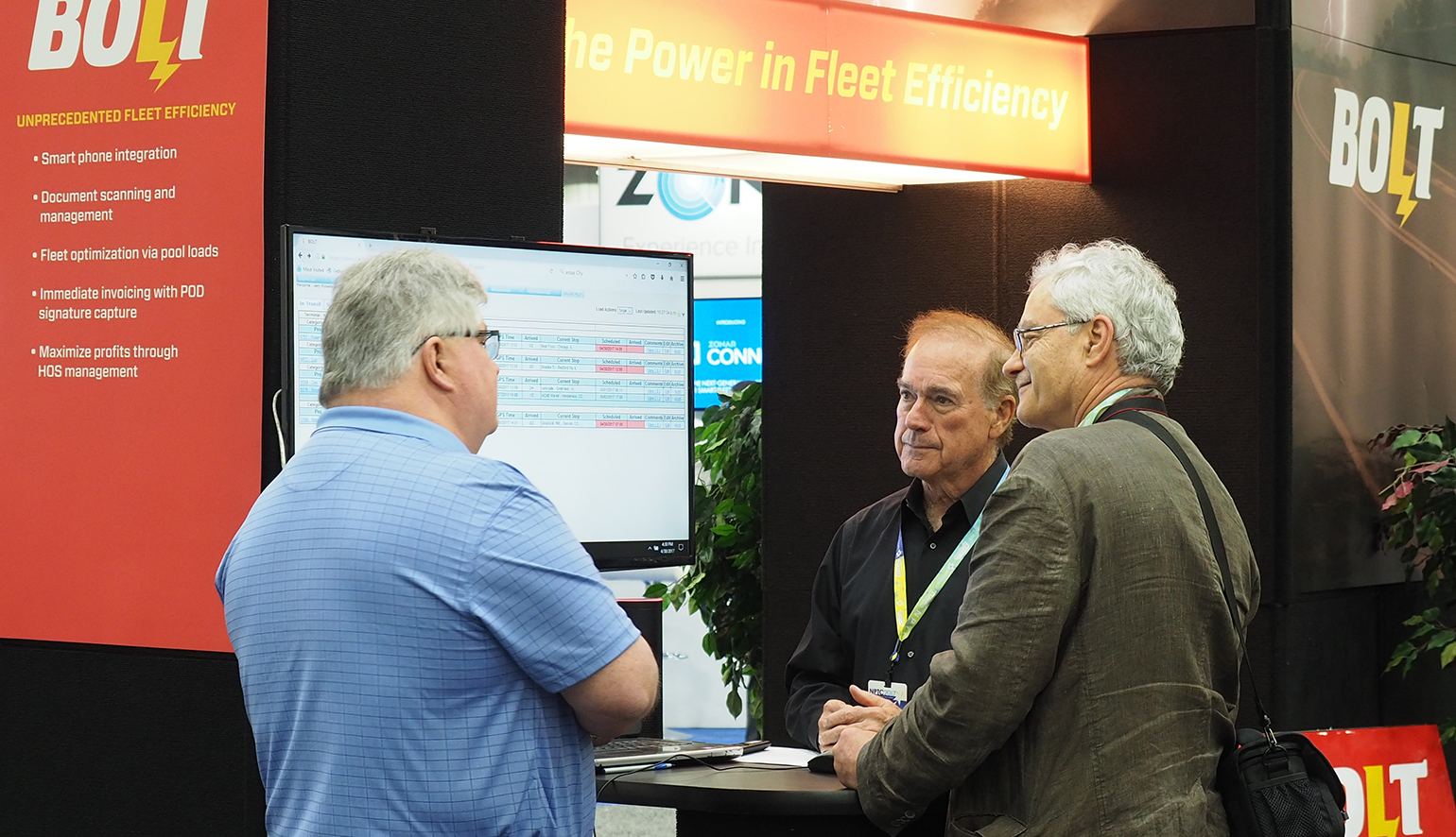 BOLT CTO Jerry Robertson center demos the company39s voiceactivated interface app for the BOLT fleet management system or FMS at the National Private Truck Council39s NPTC Annual Conference in Cincinnati