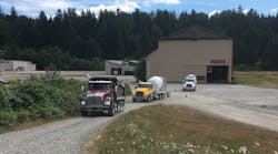 Several of Kenworth&apos;s vocational models head out for test drives on July 21 at DirtFish Rally School in Snoqualmie, WA. (Photo: Neil Abt/Fleet Owner)