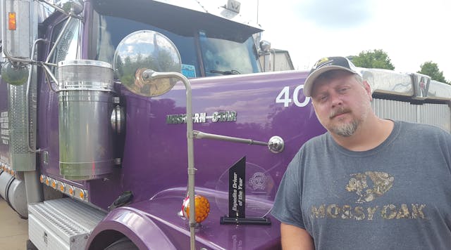 Robert Burton, an owner-operator in the V3 fleet, shown with his Expediter of the Year award, recently donated the $500 that accompanied the inaugural award to the St. Christopher Truckers Relief Fund.
